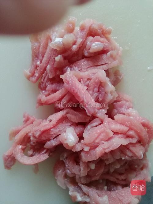 顺纹路将猪里脊肉薄片切成5厘米长肉丝;